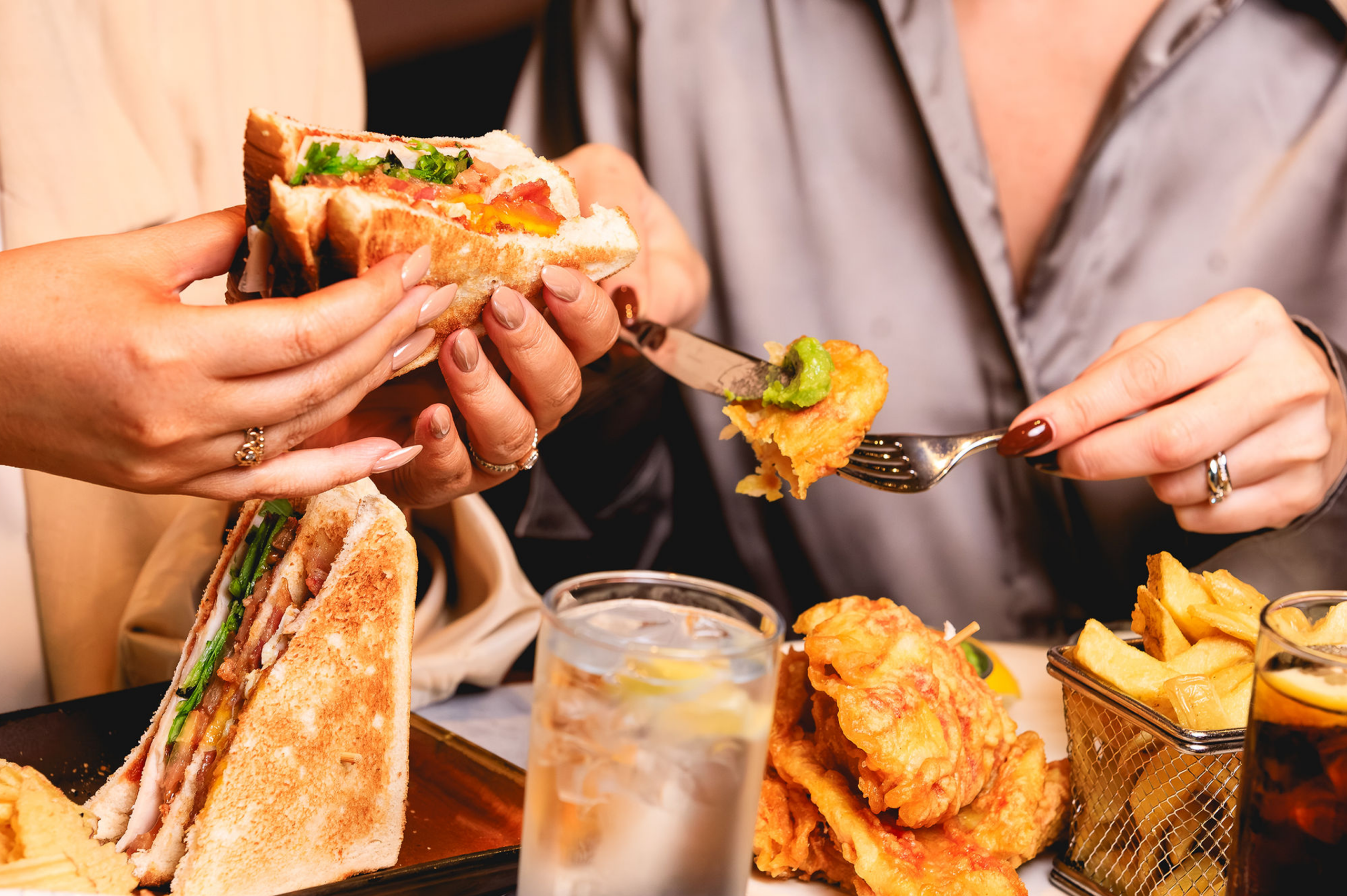 women eating sandwiches